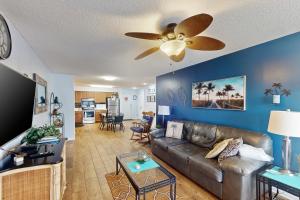 a living room with a couch and a ceiling fan at Sea Oats A203 in Gulf Shores