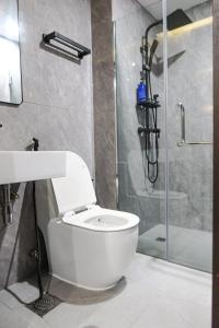 a bathroom with a white toilet and a shower at Comfy 2 Bedroom Apartment by ReCharge in Singapore +7 photos