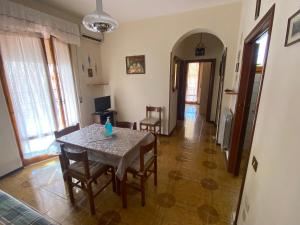 a dining room with a table and chairs in a room at Simo House in Follonica +4 photos