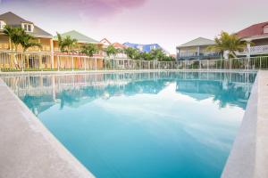 a large pool of blue water in a resort at GOLDEN SUN in Orient Bay