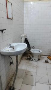 a bathroom with a sink and a toilet at Raghunath bhawan in Haridwār