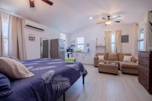 a bedroom with a bed and a living room at Casa Sirena Belize! Studio 2 in Caye Caulker