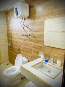 a bathroom with a toilet and a sink at Eiffel Luxora Lavender one bed in Lahore