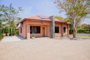 a house with a brick driveway in front of it at Villa Stone Apartments in Lusaka