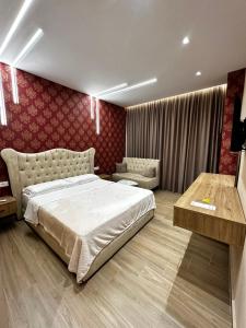 a bedroom with a king sized bed and a couch at Dedej Rooms in Durrës