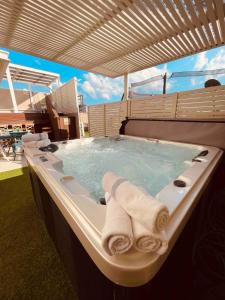 a bath tub with towels on top of it at אלמה בוטיק - וילה מהממת עם בריכה פרטית in Shlomi