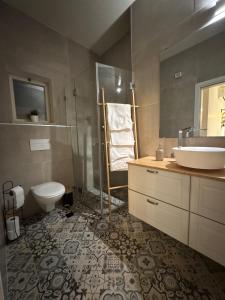 a bathroom with a toilet and a sink at אלמה בוטיק - וילה מהממת עם בריכה פרטית in Shlomi +15 photos