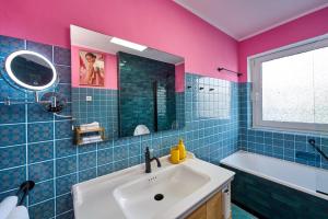 a bathroom with a sink and a mirror and a tub at Eifelgold Ferienwohnung in Daun +27 photos