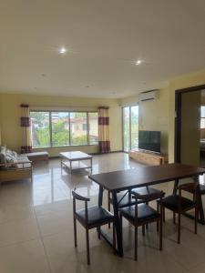 a large living room with a table and chairs at Central Apartment in Nadi