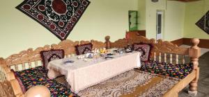 a dining room with a table and chairs at AMIRSHOX GUEST HOUSE in Samarkand