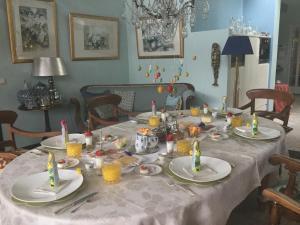 a table with plates and candles on top of it at B&B lux Schijndel in Schijndel
