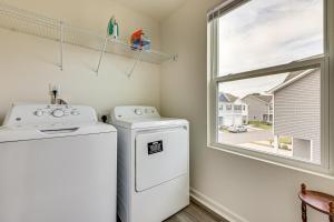 a laundry room with a washer and dryer and a window at Screened Patio Townhome 3 Mi to Dtwn Wilson! in Wilson