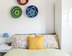a bedroom with a bed with plates on the wall at #09 Stylish 2 bed Apart Sleep 5 fast Wi-fi BHX NEC in Shirley
