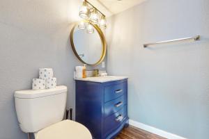a bathroom with a white toilet and a mirror at Glendale Groovin' in Glendale +17 photos