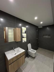 a bathroom with a sink and a toilet at Agadir Vibes 3 appartements & 1 studio modernes au cœur de la ville in Agadir +27 photos