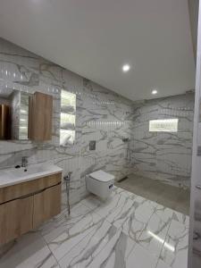 a bathroom with a sink and a toilet in it at Agadir Vibes 3 appartements & 1 studio modernes au cœur de la ville in Agadir