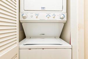 a white oven sitting in a kitchen next to a door at Emerald Skye 42 in Orange Beach