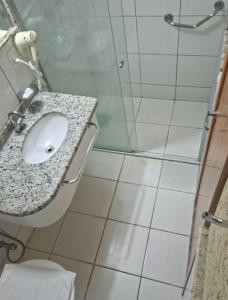 a bathroom with a shower and a sink and a toilet at Golden Dolphin Grand Hotel in Caldas Novas