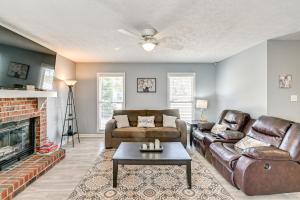 a living room with a couch and a fireplace at Large Yard, Office Space Fayetteville Family Home in Hope Mills