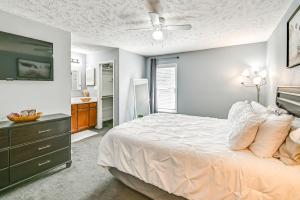 a bedroom with a bed and a dresser with a television at Large Yard, Office Space Fayetteville Family Home in Hope Mills