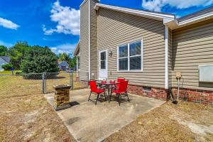 a patio with a table and chairs in front of a house at Large Yard, Office Space Fayetteville Family Home in Hope Mills