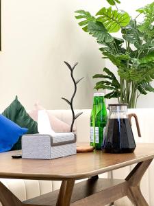 a wooden coffee table with two bottles on it at Апарт-отель Urban Luxe Nest one Sky-High Luxury in Tashkent