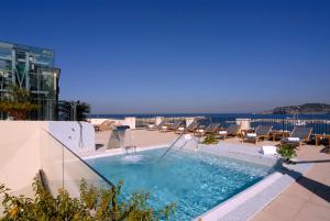 a swimming pool on the roof of a building at Hotel Villa Carolina in Forio d'Ischia