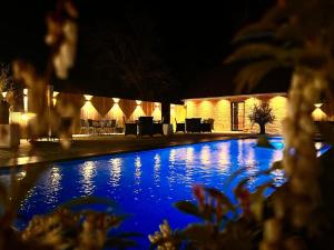 a swimming pool in front of a building at night at Sparhof in Dranouter