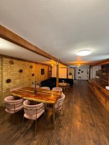 a dining room with a wooden table and chairs at Old Town Penthouse 16 guests in Bucharest