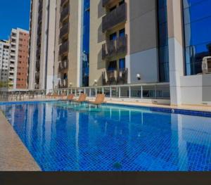 a large swimming pool in front of some buildings at FLAT 313 S4 Hotel in Brasília