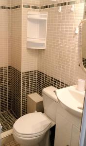 a bathroom with a white toilet and a sink at Pefko Couple's Cave in Pefkohori