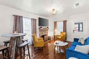 a living room with a blue couch and a fireplace at Mystic Moon- family friendly fenced yard pets welcome in Port Saint Joe
