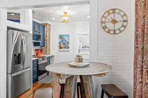 a kitchen with a table and a clock on the wall at Mystic Moon- family friendly fenced yard pets welcome in Port Saint Joe
