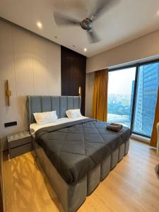 a bedroom with a bed with a ceiling fan at Sun n Sapphire - Book Half Day or Night in Ghaziabad