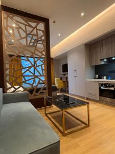 a living room with a couch and a table at Sun n Sapphire - Book Half Day or Night in Ghaziabad