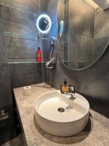 a bathroom with a sink and a mirror at Sun n Sapphire - Book Half Day or Night in Ghaziabad