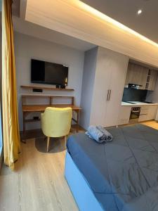 a room with a bed and a desk with a television at Sun n Sapphire - Book Half Day or Night in Ghaziabad