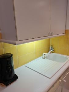 a kitchen counter with a sink and a faucet at Perle de la côte in Menton +14 photos