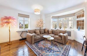 a living room with a couch and a table at ROYAL Apartment in HARRODS in London