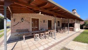a patio with tables and chairs on a brick building at Casa-Quinta Citrino - Viña, Buenos Aires in Viña