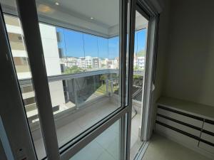a balcony with a view of the city from a building at Cód 56 · Apartamento amplo bem equipado in Governador Celso Ramos