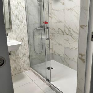 a shower with a glass door in a bathroom at La Marina in Alicante