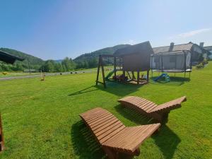 a park with a bench and a playground at Domki Wichrowe Wzgórze Bieszczady in Bukowiec