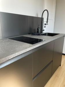 a kitchen with a sink and a counter top at Apartament Imperial Przedmieście in Grudziądz +3 photos