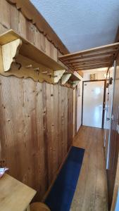 a room with wooden walls and a room with a door at Les Menuires sur les pistes in Les Menuires