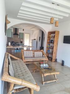 a living room with two couches and a table at Petite villa- Tamezrat- Kelibia in Kelibia