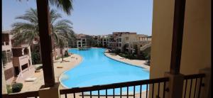 a view of a swimming pool from a balcony at Private Apartment One bed room at Talabay -Independent Listing in Aqaba