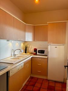 a kitchen with a white refrigerator and a microwave at Appartement luxe Spa & Golf - Domaine privé in Saint-Cyr-sur-Mer +15 photos