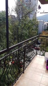 a fence with many wine bottles on a balcony at Spacious and Bright 2BR Apartment near City Center in Skopje