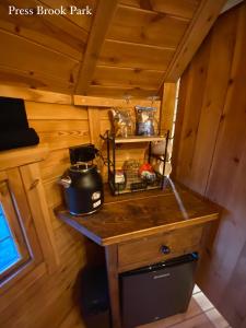 a kitchen with a counter in a wooden cabin at Press Brook Park in Clay Cross